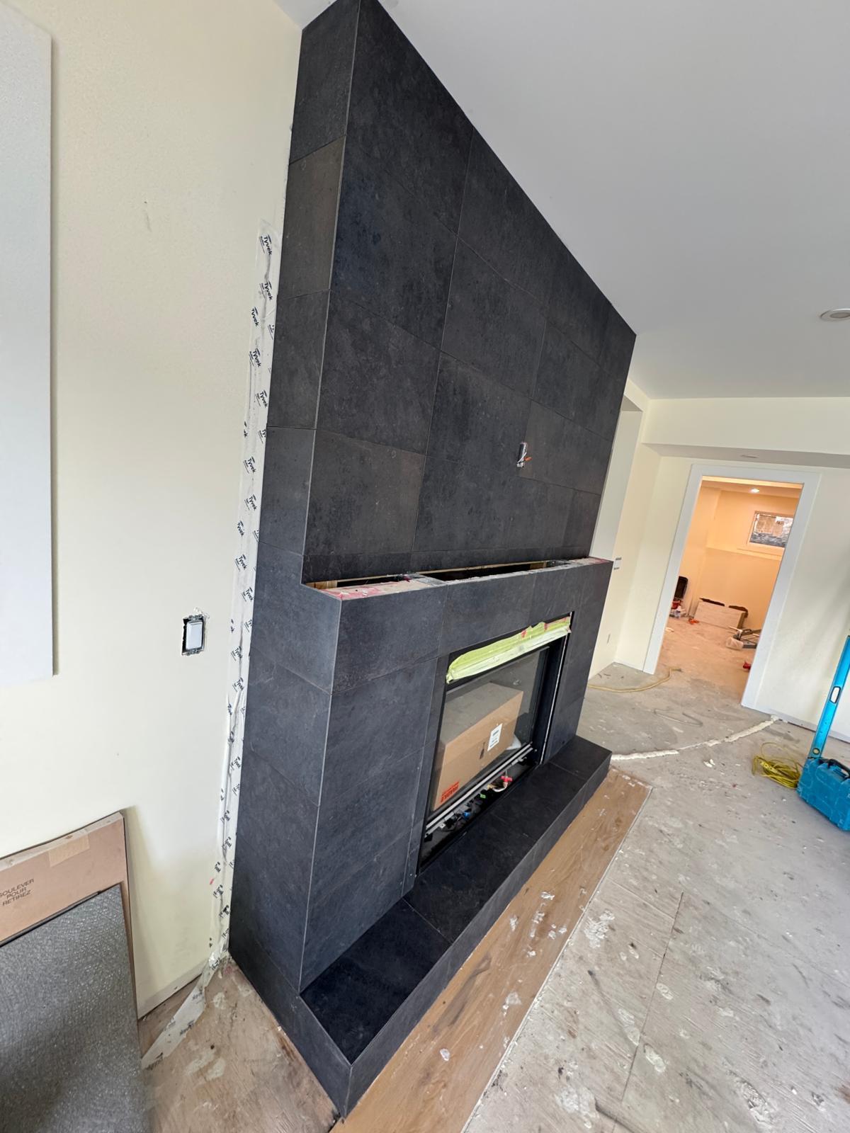 Black floor to ceiling fireplace