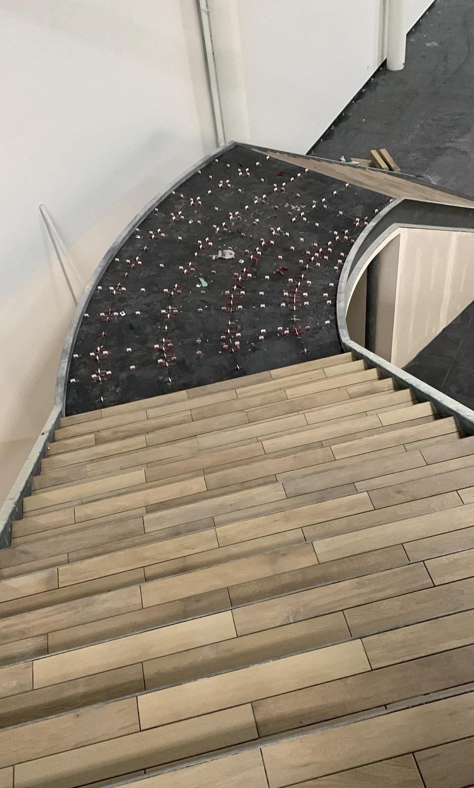 Curved staircase wood look tile