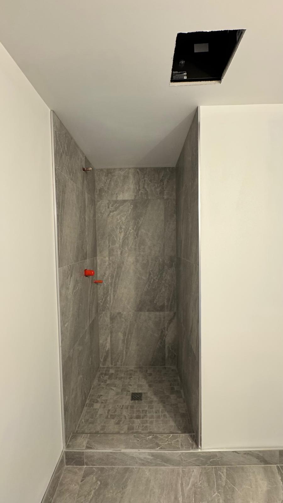 Gray marble walk-in shower with niche