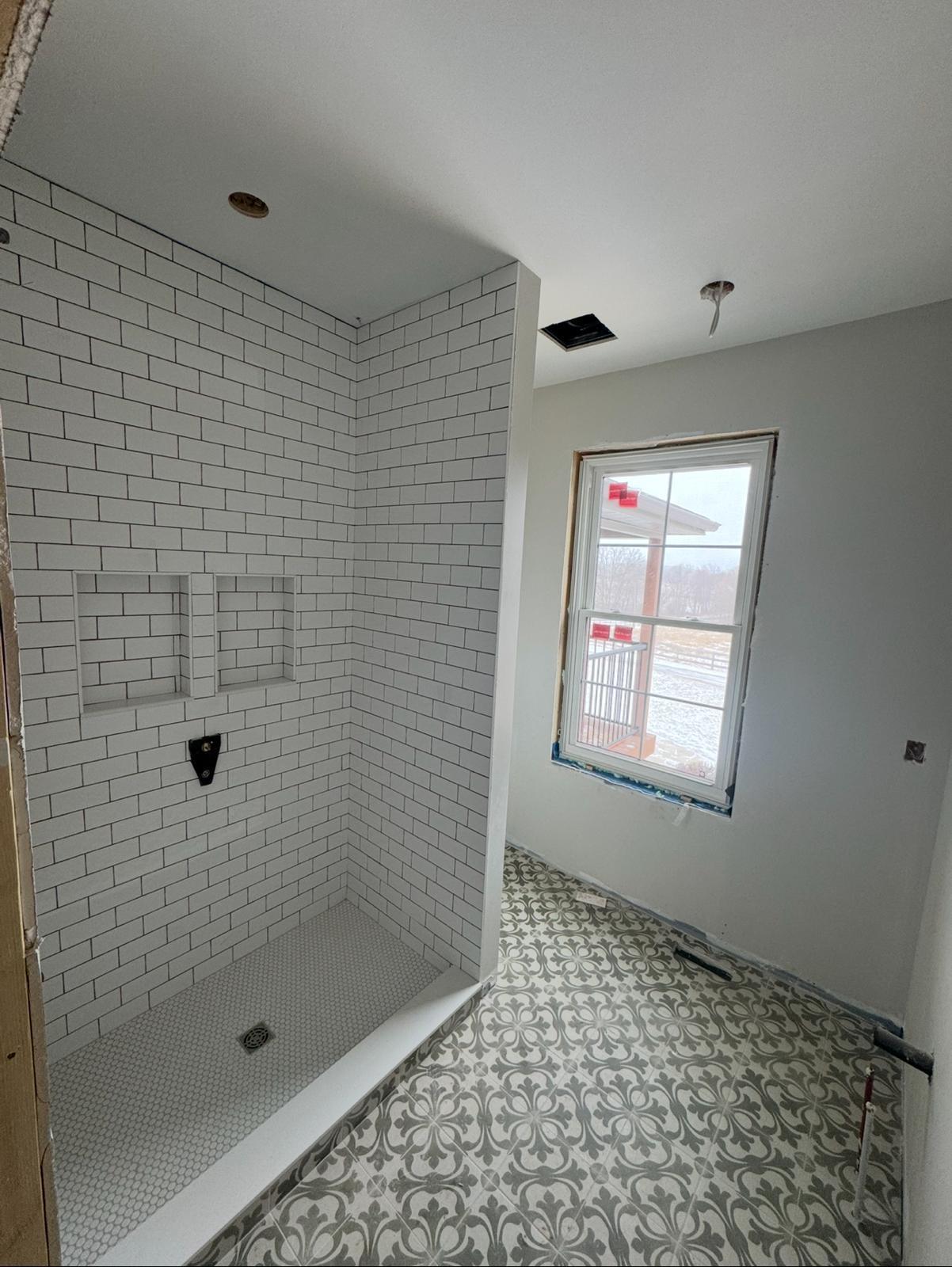 White subway tile shower hexagon floor
