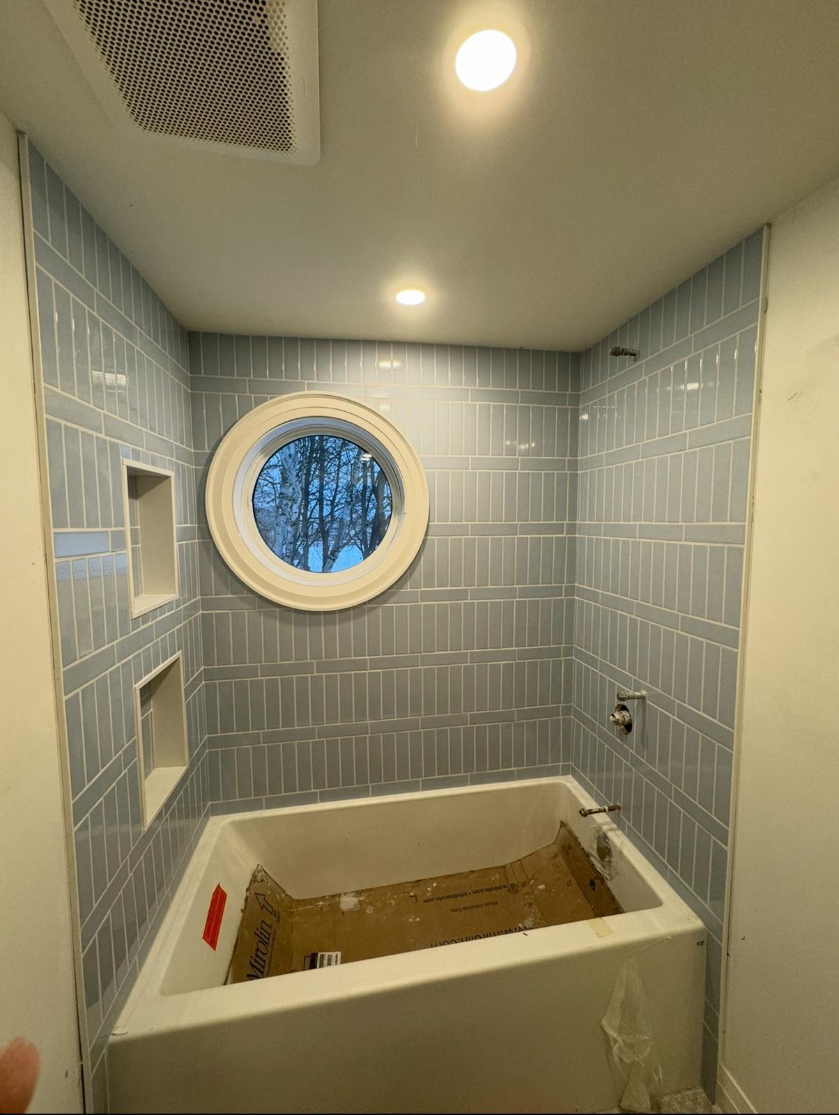 Blue gray tub surround porthole window